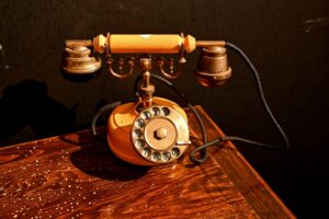 Antique rotary telephone on a wooden table