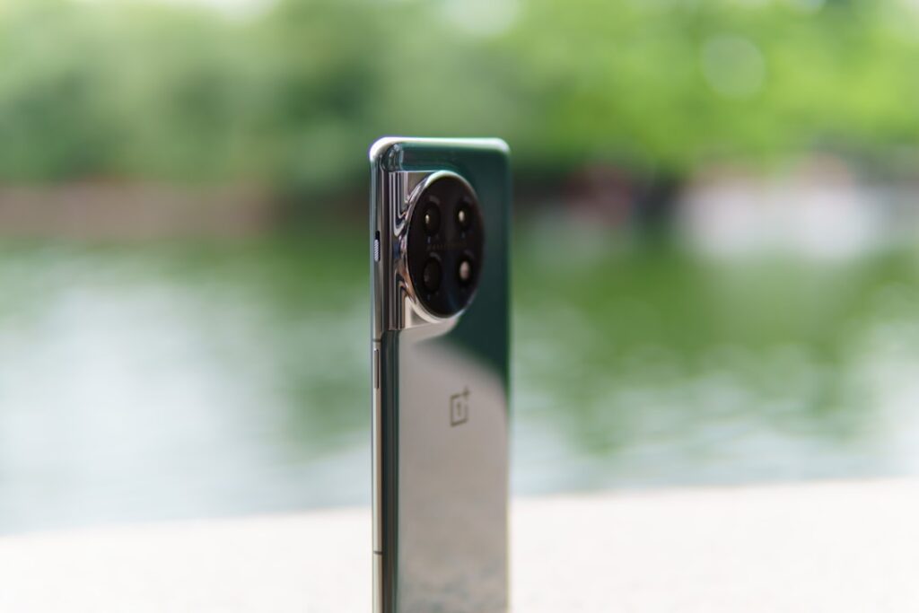 a close up of a cell phone near a body of water