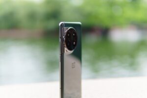 a close up of a cell phone near a body of water