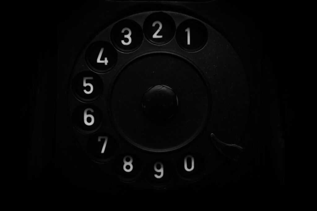 A close up of an old fashioned phone in the dark