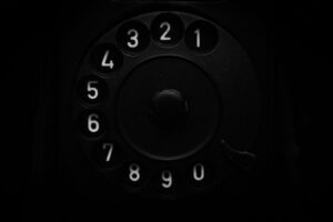 A close up of an old fashioned phone in the dark