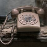 an old fashioned phone sitting on a window sill