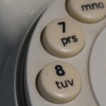 Close-up of old rotary phone dial buttons.