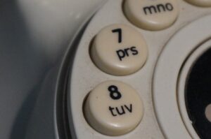 Close-up of old rotary phone dial buttons.