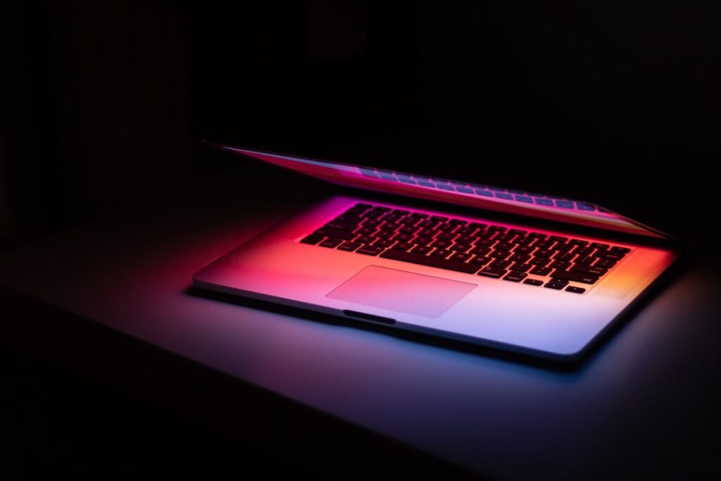 macbook pro on black table