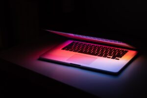 macbook pro on black table