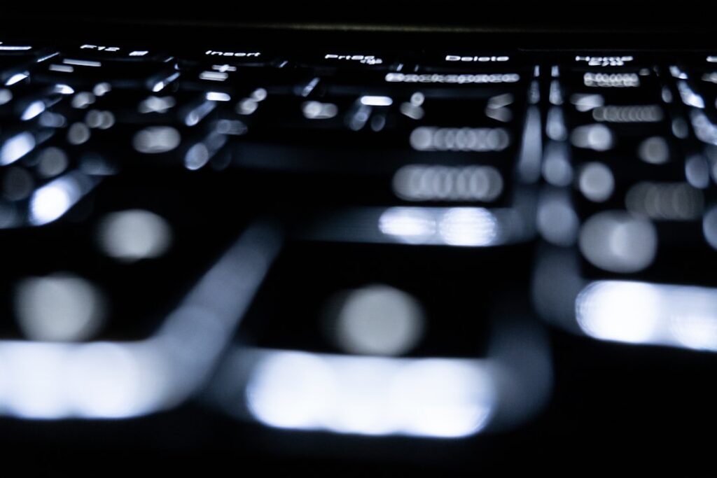 Close-up of a backlit keyboard in the dark.