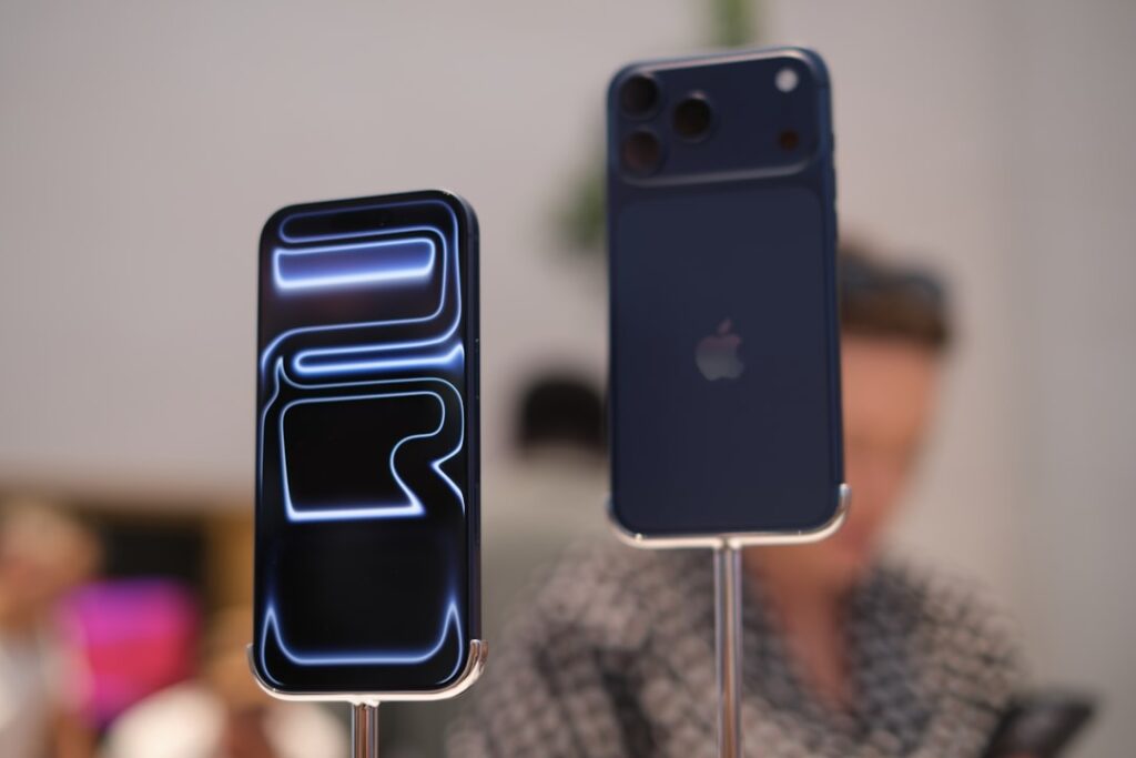 Two smartphones displayed with glowing abstract design.