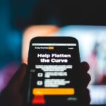 a person holding a cell phone in their hand