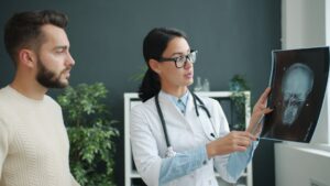Doctor explains skull x-ray to patient